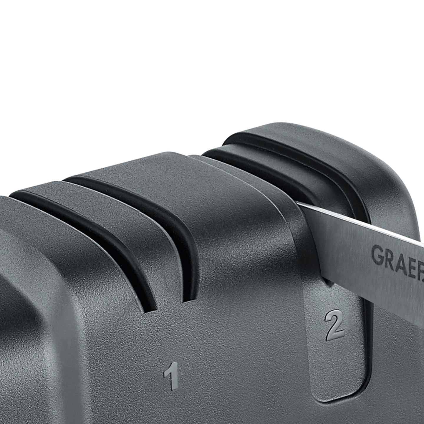 Close-up of a knife sharpener with numbers 1 and 2 and the brand name GRAEF.