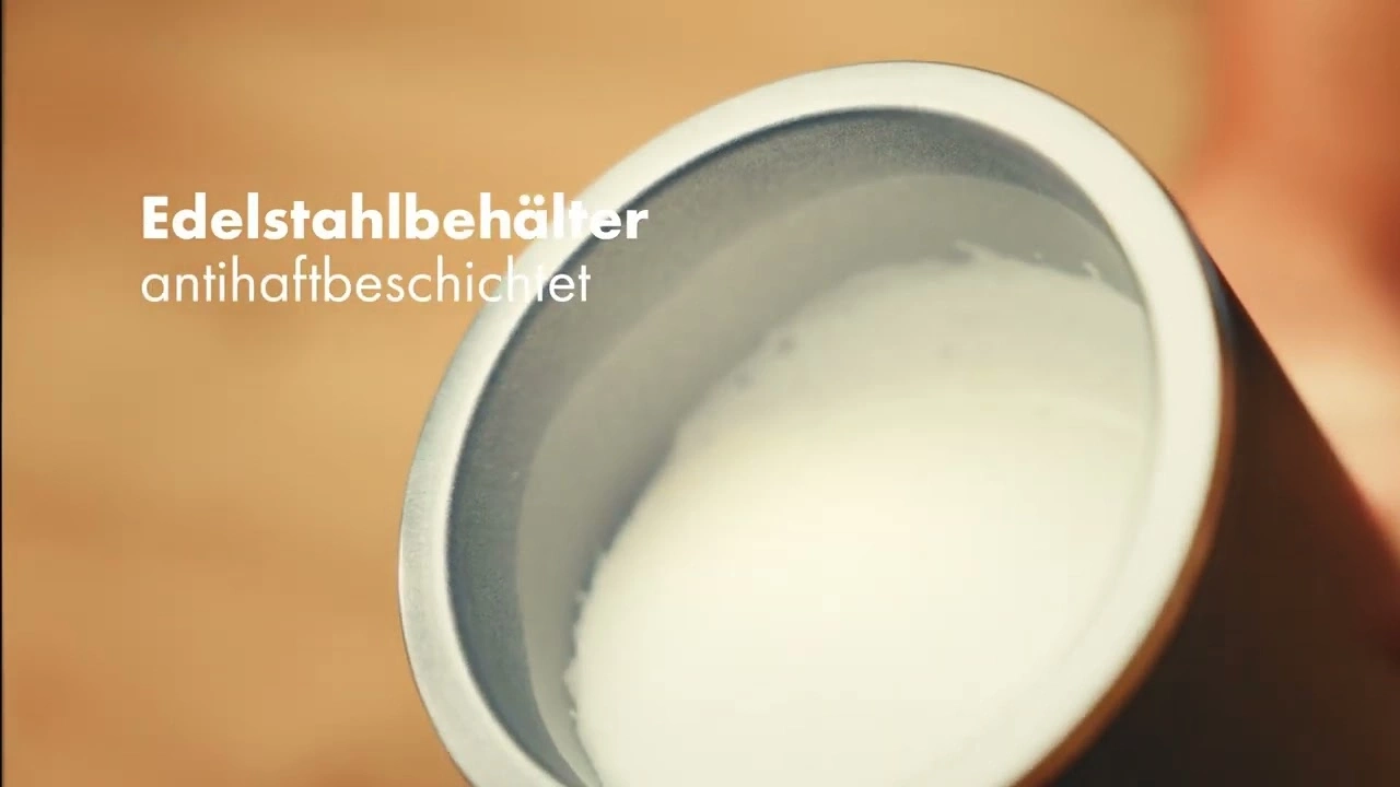 Stainless steel container with non-stick coating filled with milk, close-up shot