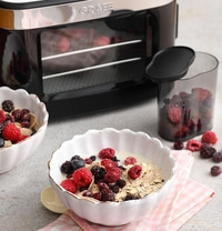 Breakfast with berries and cereal, oven in background, delicious food