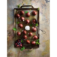 Chocolate balls on tray with berries and mint, delicious and appetizing