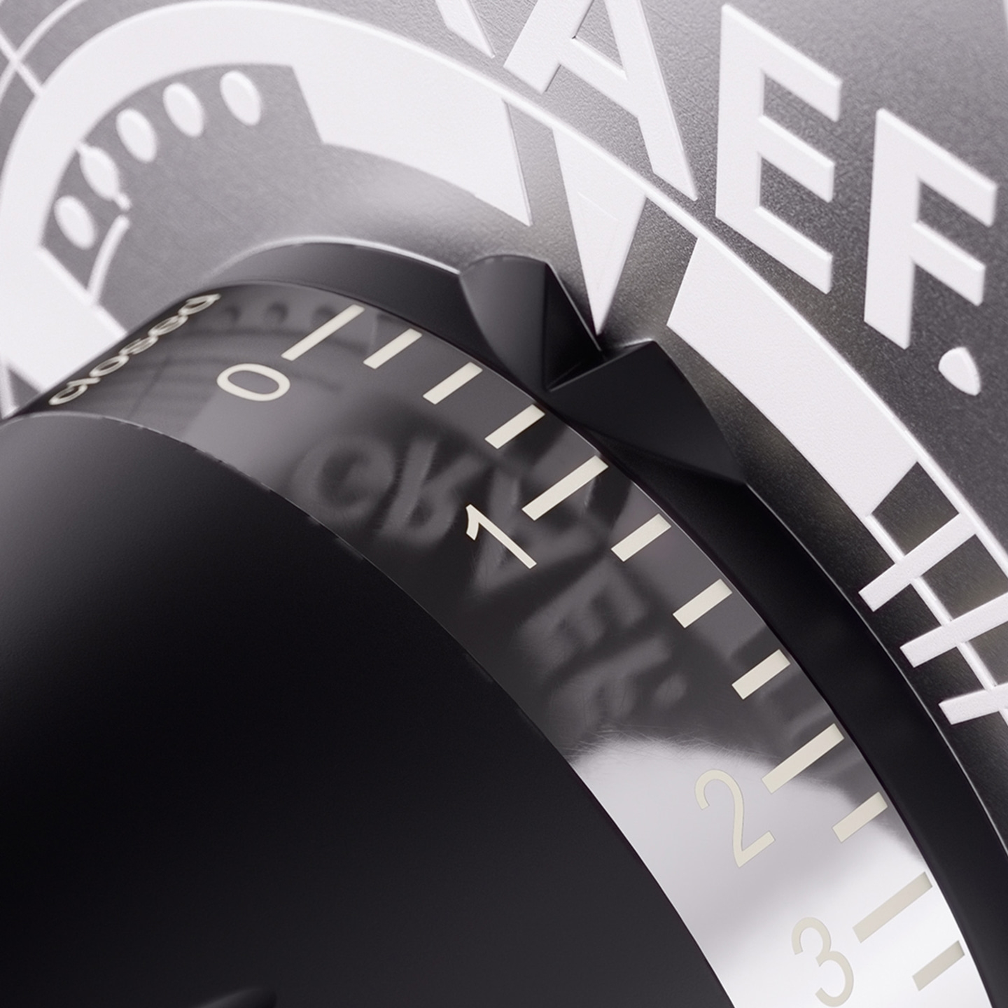 Close-up of a black dial with white markings and numbers, showing detail.