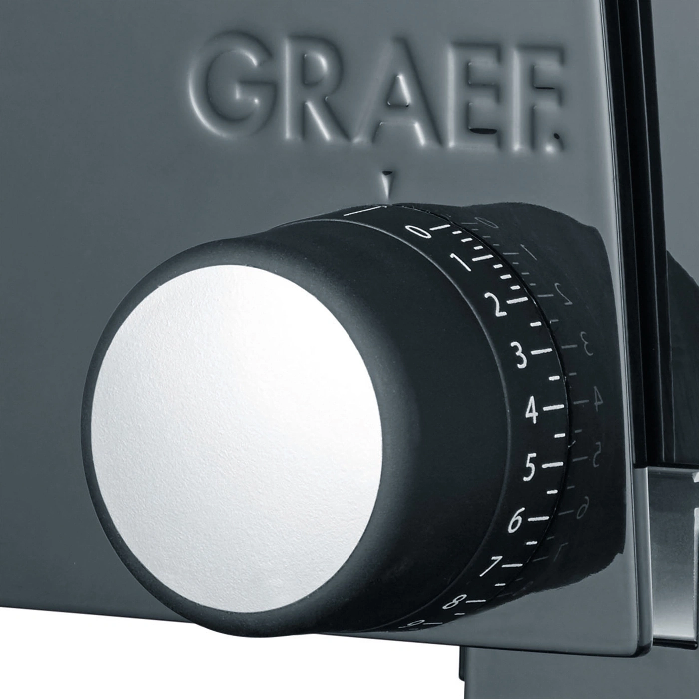 Close-up of a Graef slicer's dial with numbers and markings for thickness adjustment.