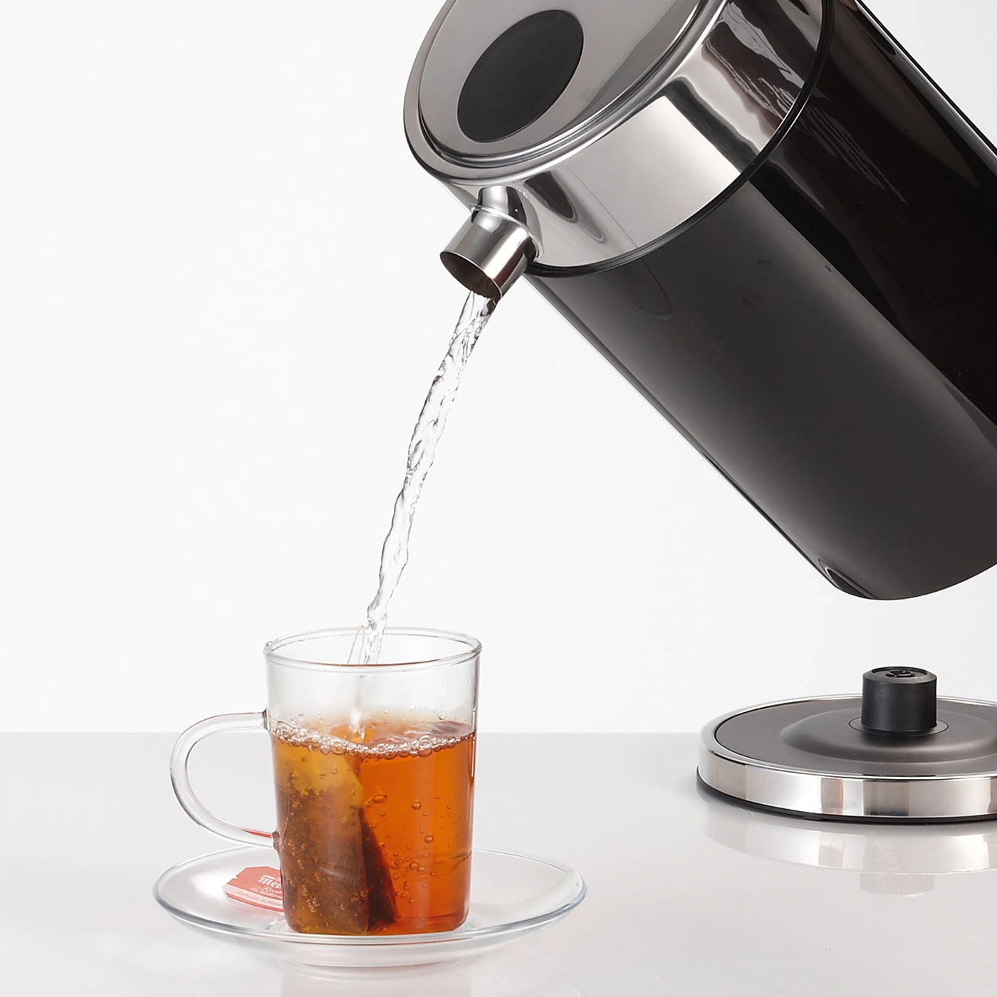 Water is poured into a cup with a tea bag.