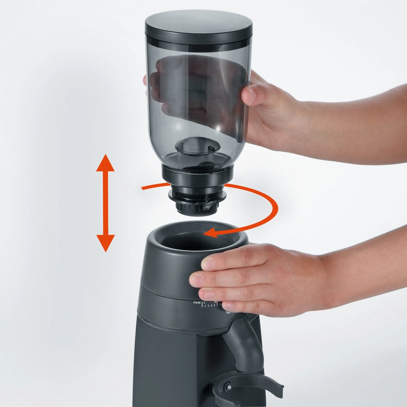 Coffee grinder being disassembled for cleaning or refilling with coffee beans.