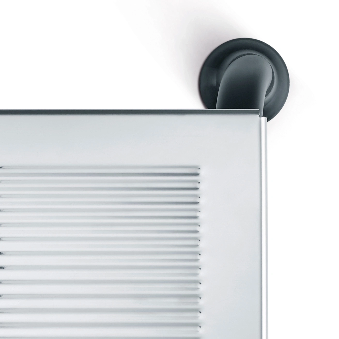 Close-up of a silver object with a black pipe against a white background.