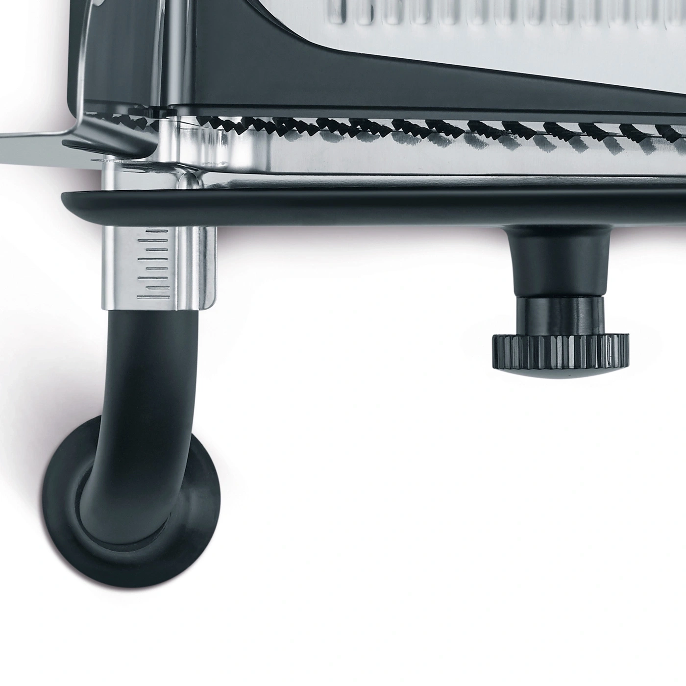 Close-up of a black kitchen tool with a measurement scale and adjustment wheel