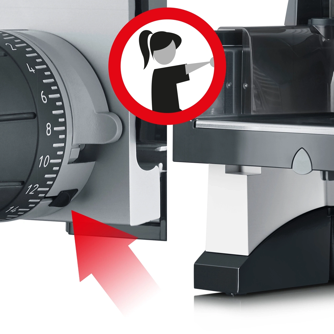 Safety sign on a slicer with red arrow and woman symbol, indicating danger