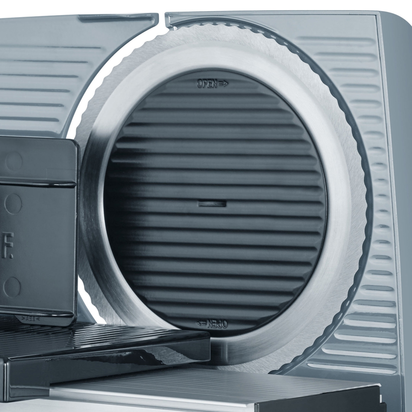 Close-up of an electric meat slicer showing the detailed blade and controls.