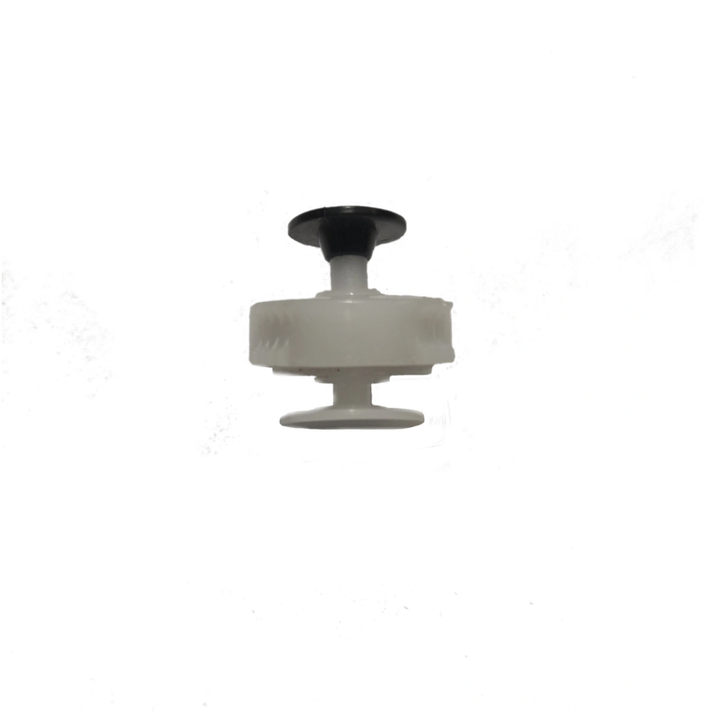 White plastic part with black button isolated on white background
