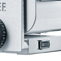 Close-up of a silver appliance with an on/off switch and a numbered scale.