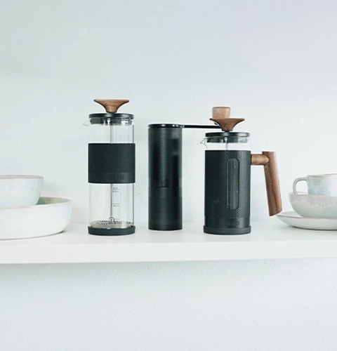Coffee maker, grinder, and cup on a shelf in a minimalist style