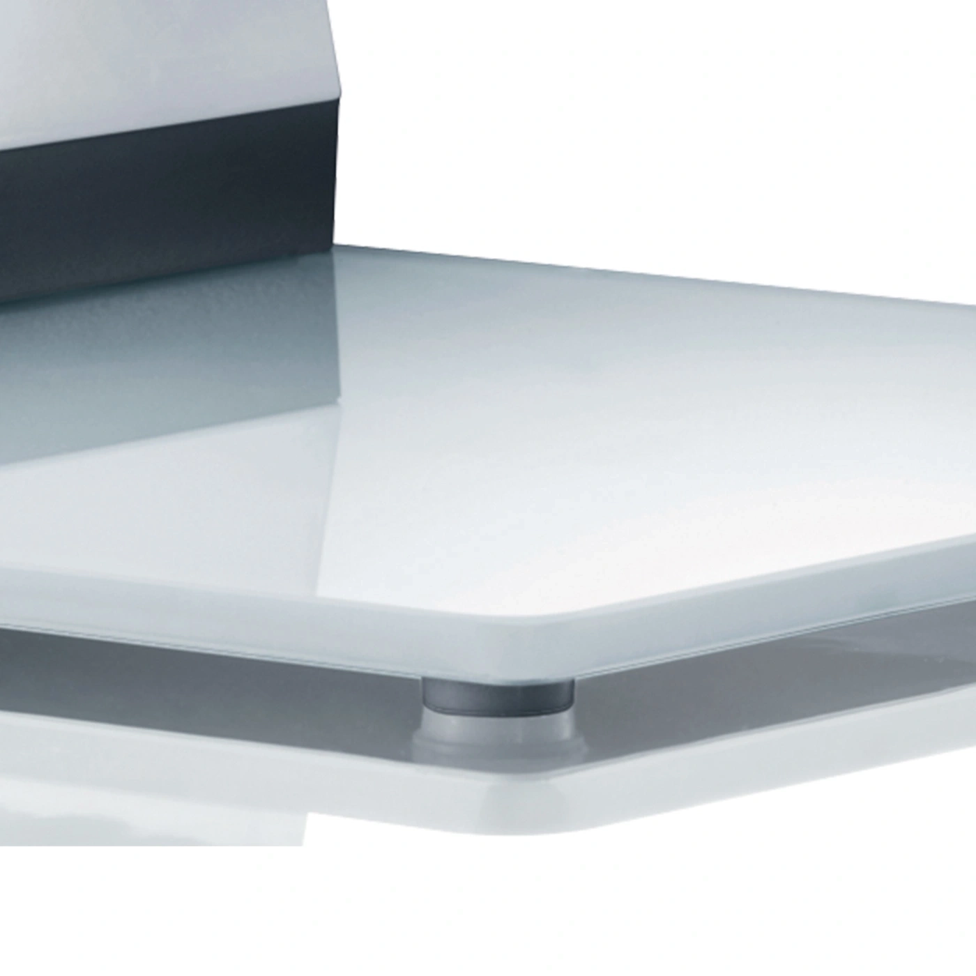 Close-up of a glass shelf with a dark edge and silver supports.