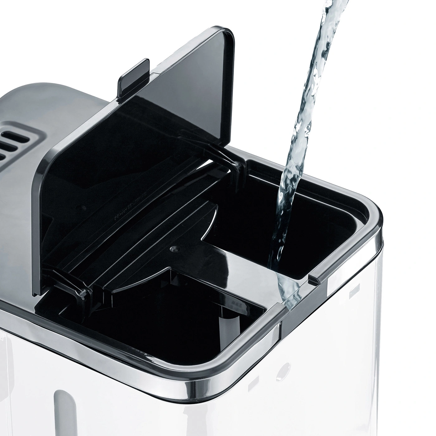 Water being poured into a container with a lid open, close up shot.