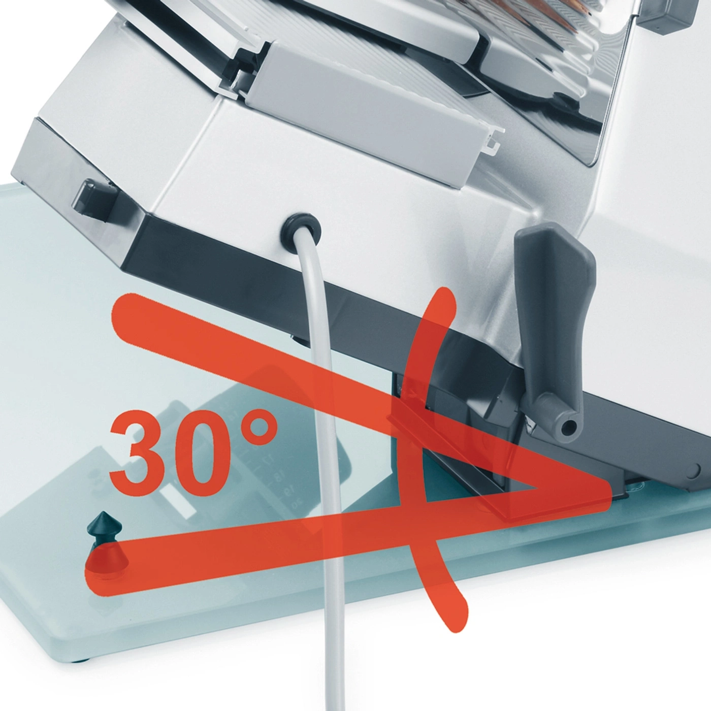 A meat slicer at a 30-degree angle, resting on a light blue surface.