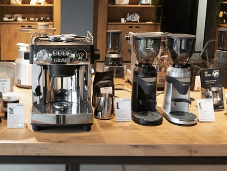 Coffee machine and grinders on a wooden table in a shop display