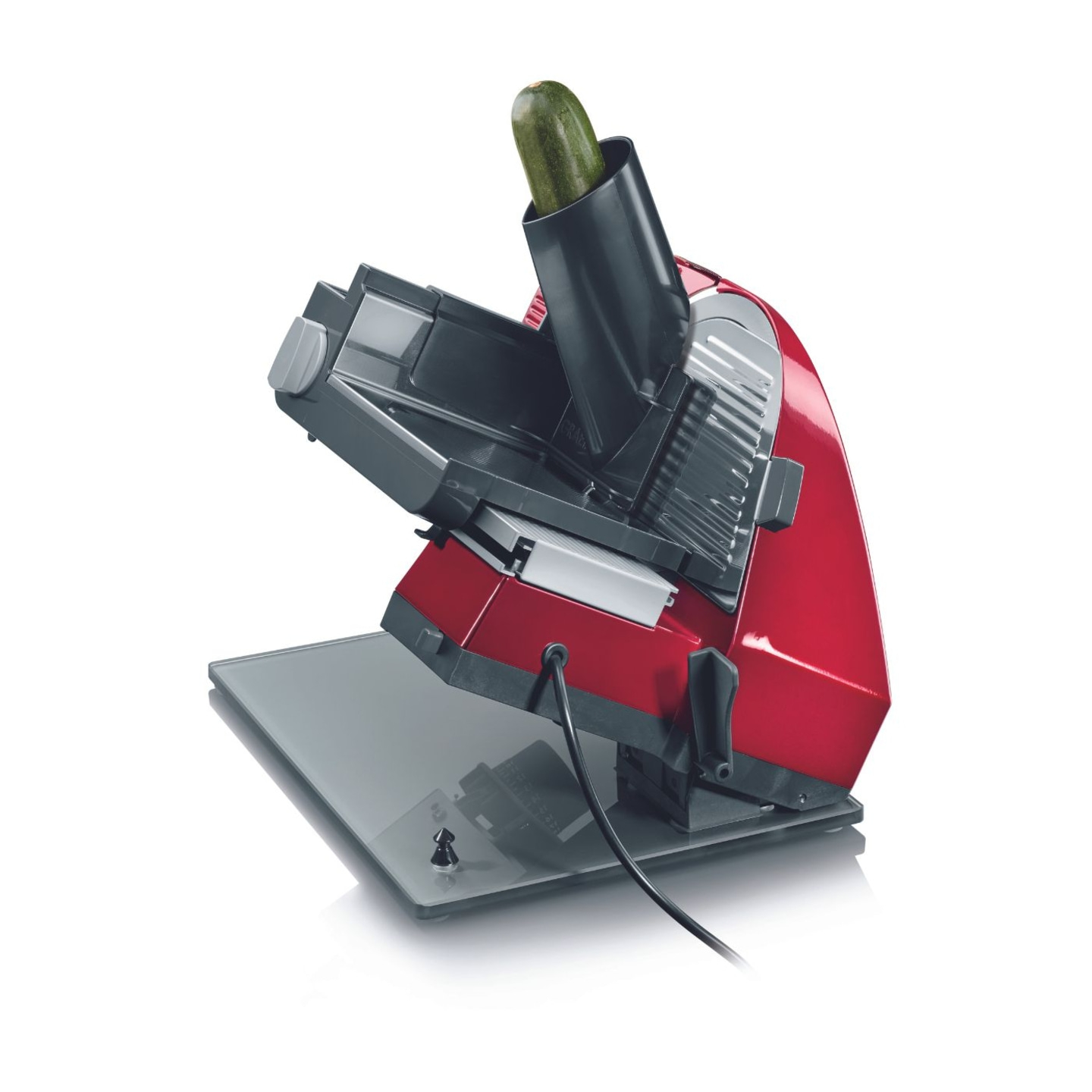 Roter elektrischer Gemüseschneider mit Zucchini. Küchengerät zum Schneiden von Gemüse.