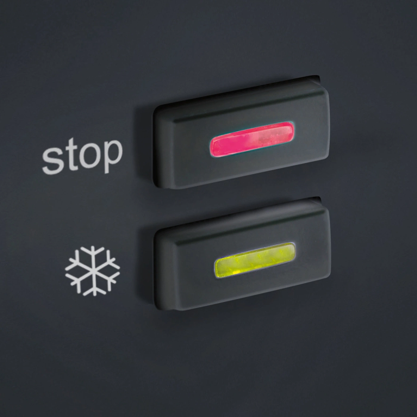 Black control panel with two illuminated buttons and a snowflake symbol.