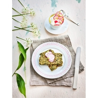 Delicious food with radishes and herbs on a plate, decorated with flowers