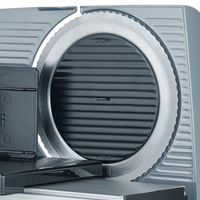 Close-up of an electric meat slicer showing the detailed blade and controls.