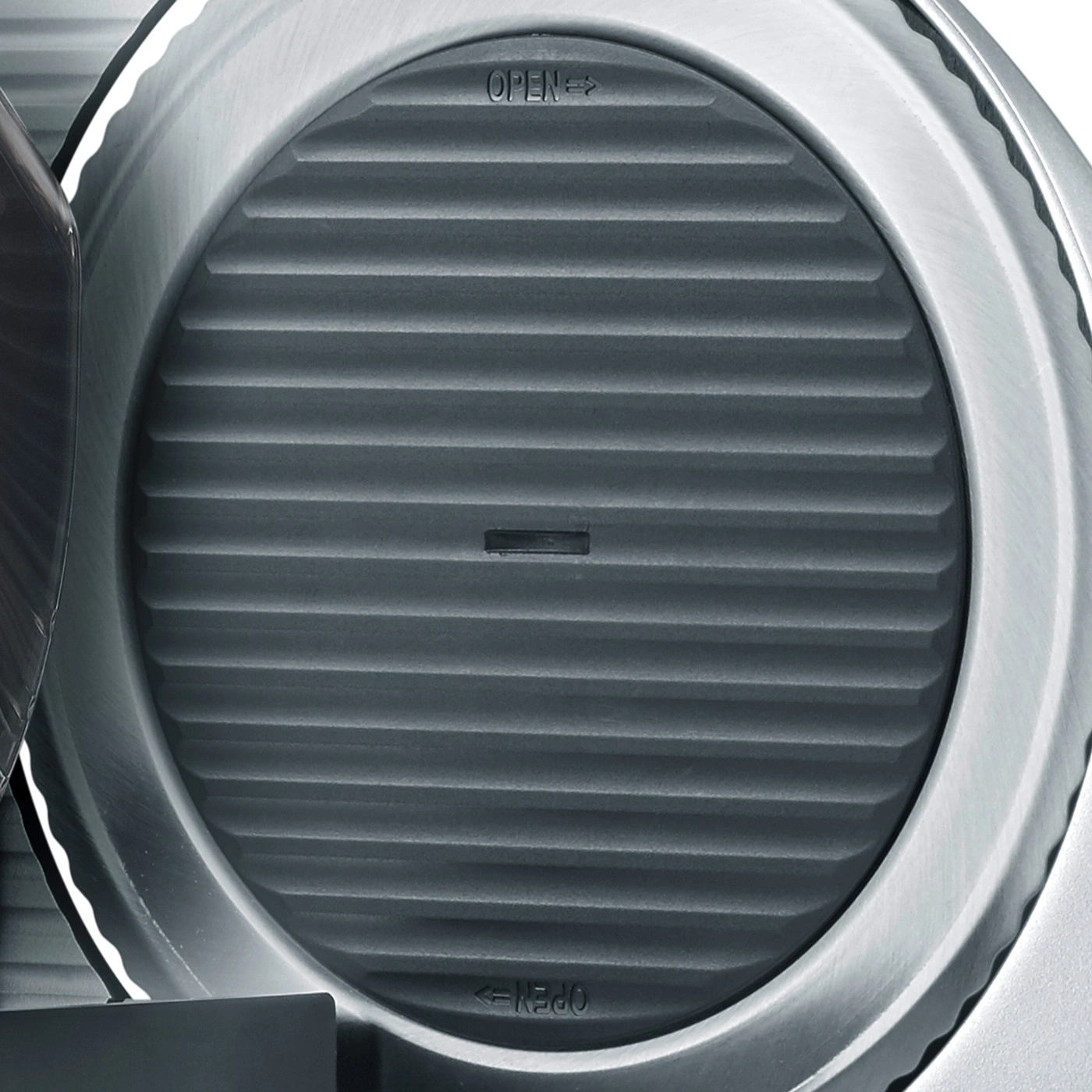 Close-up of a gray, ridged circle with 'OPEN' and 'OPEN' labeling on it.