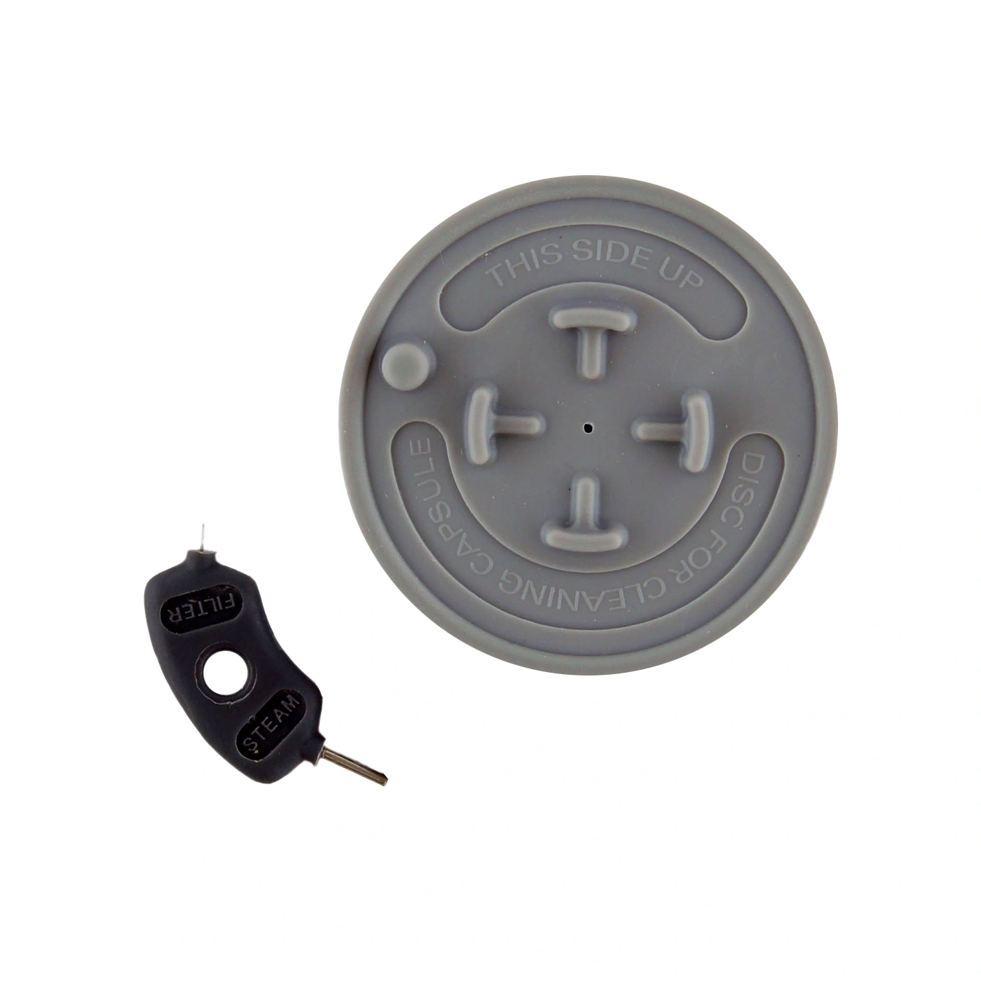 Gray disc with text and black cleaning pin for coffee machine, top view.