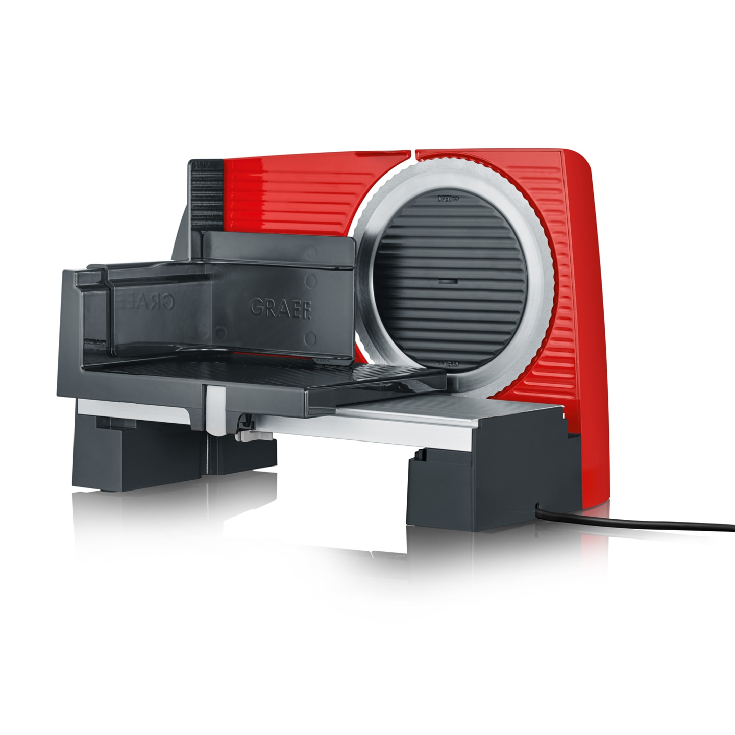 Red electric slicer with metal blade and black carriage.