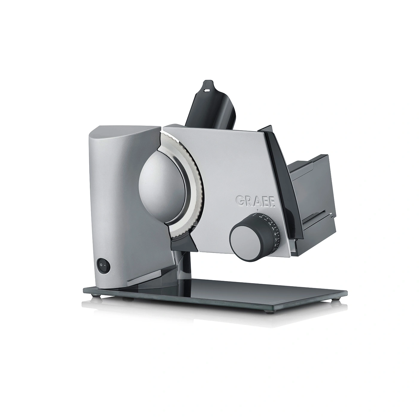 Silver Graef slicer with knob and blade, standing on a glass plate, kitchen appliance.
