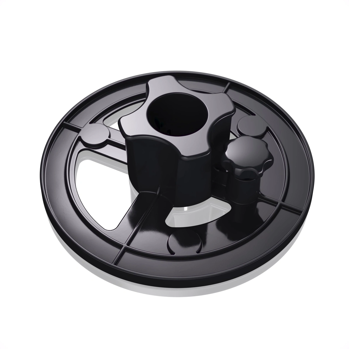 Black plastic part with knobs and holes, isolated on a white background, shiny.