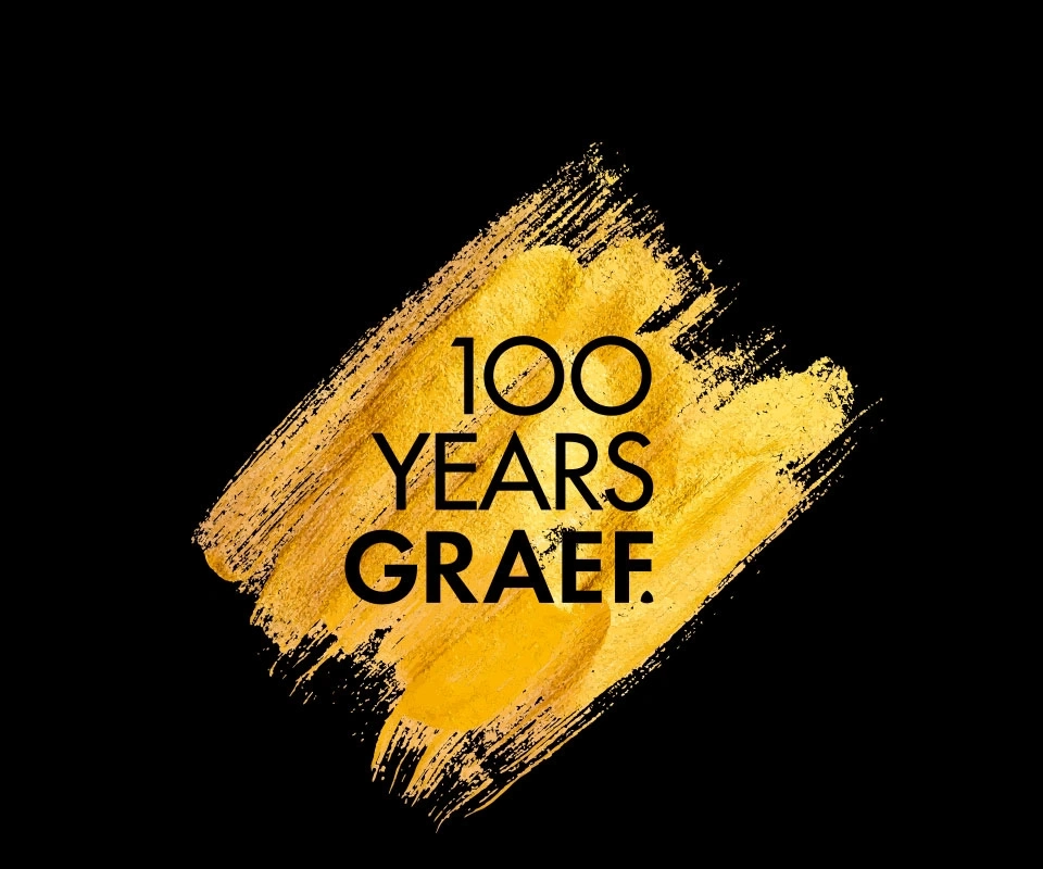 Golden brushstroke with text: 100 YEARS GRAEF on a black background.
