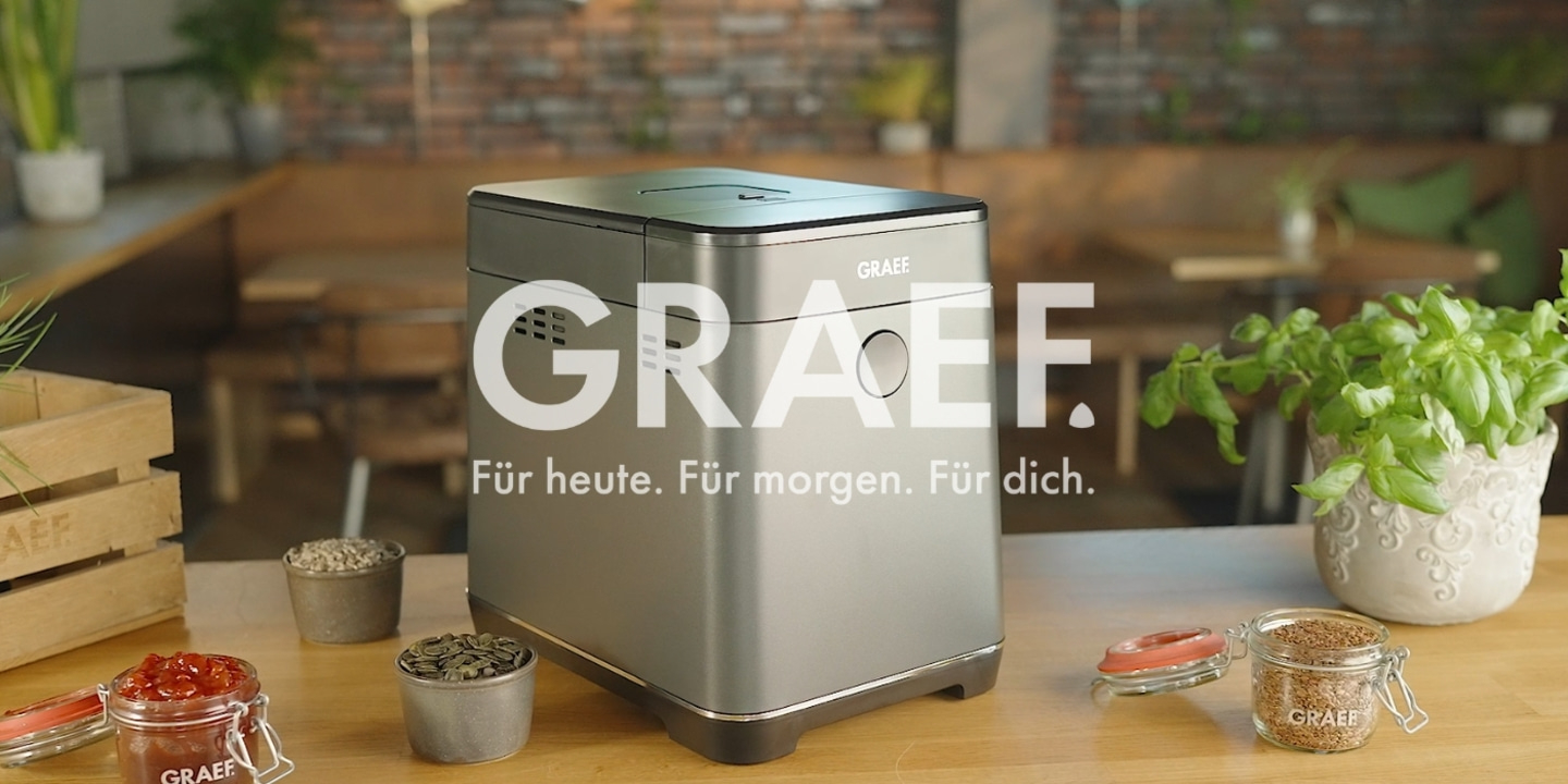 Graef bread maker with ingredients on a wooden table in a restaurant