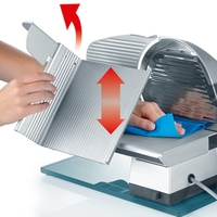 Cleaning a slicer with a blue cloth, arrows indicating movement and direction