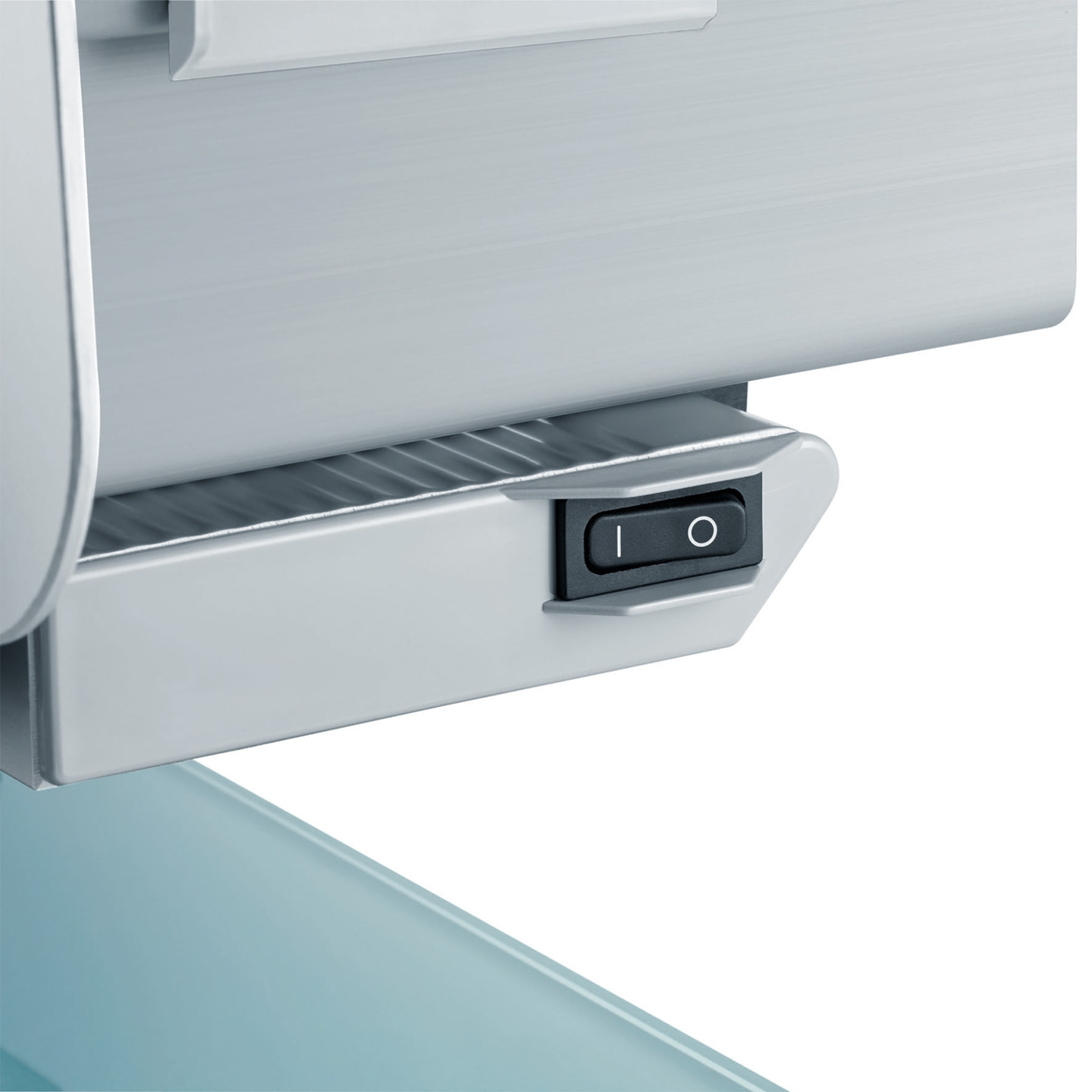 Close-up of an on-off switch on a device, resting on a blue surface.