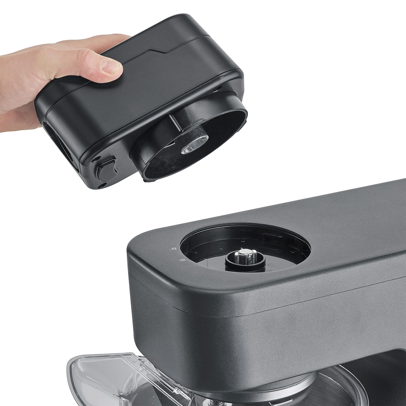 Hand holding black device being inserted into another black device.