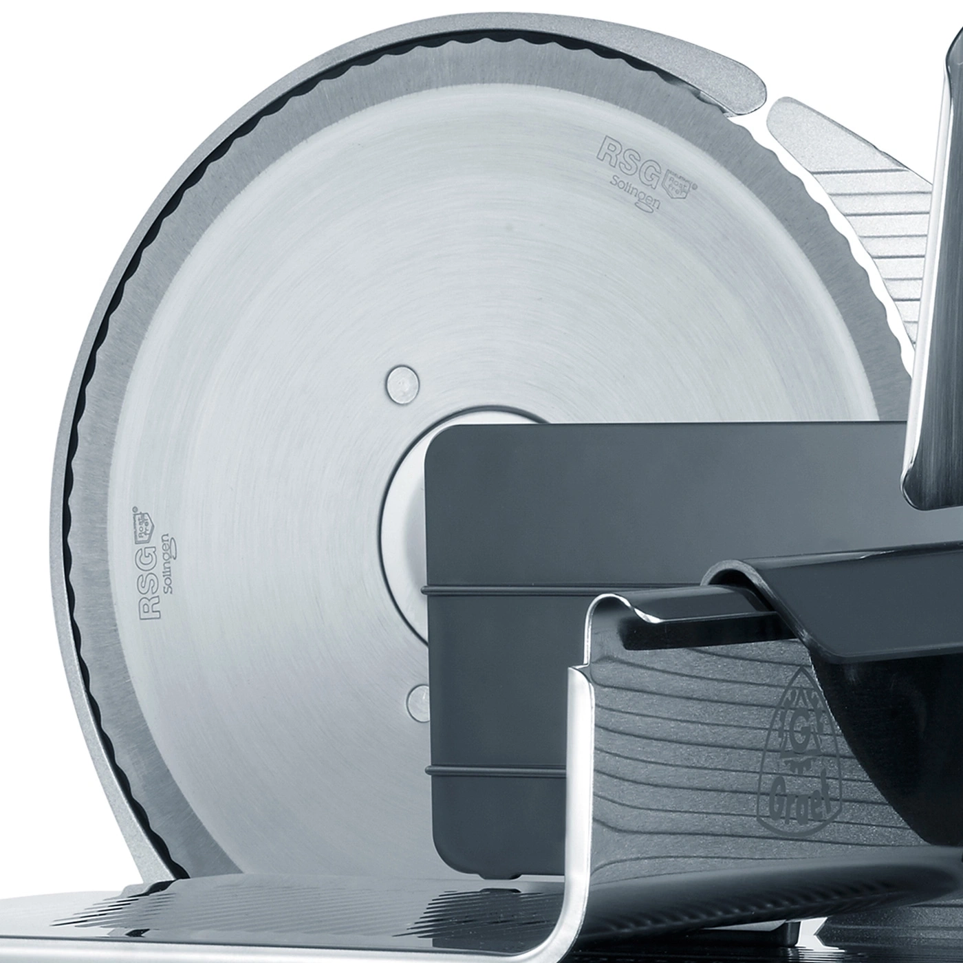 Close-up of a meat slicer with a sharp blade and intricate details