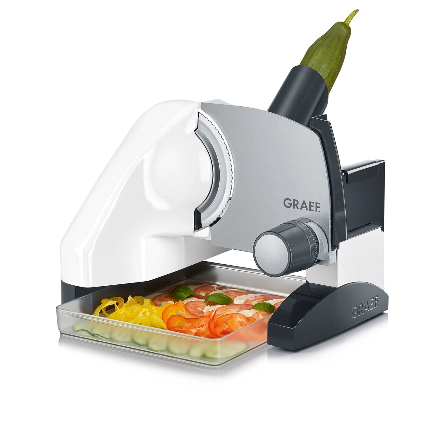 Graef slicer with vegetables and tomatoes in the collection tray