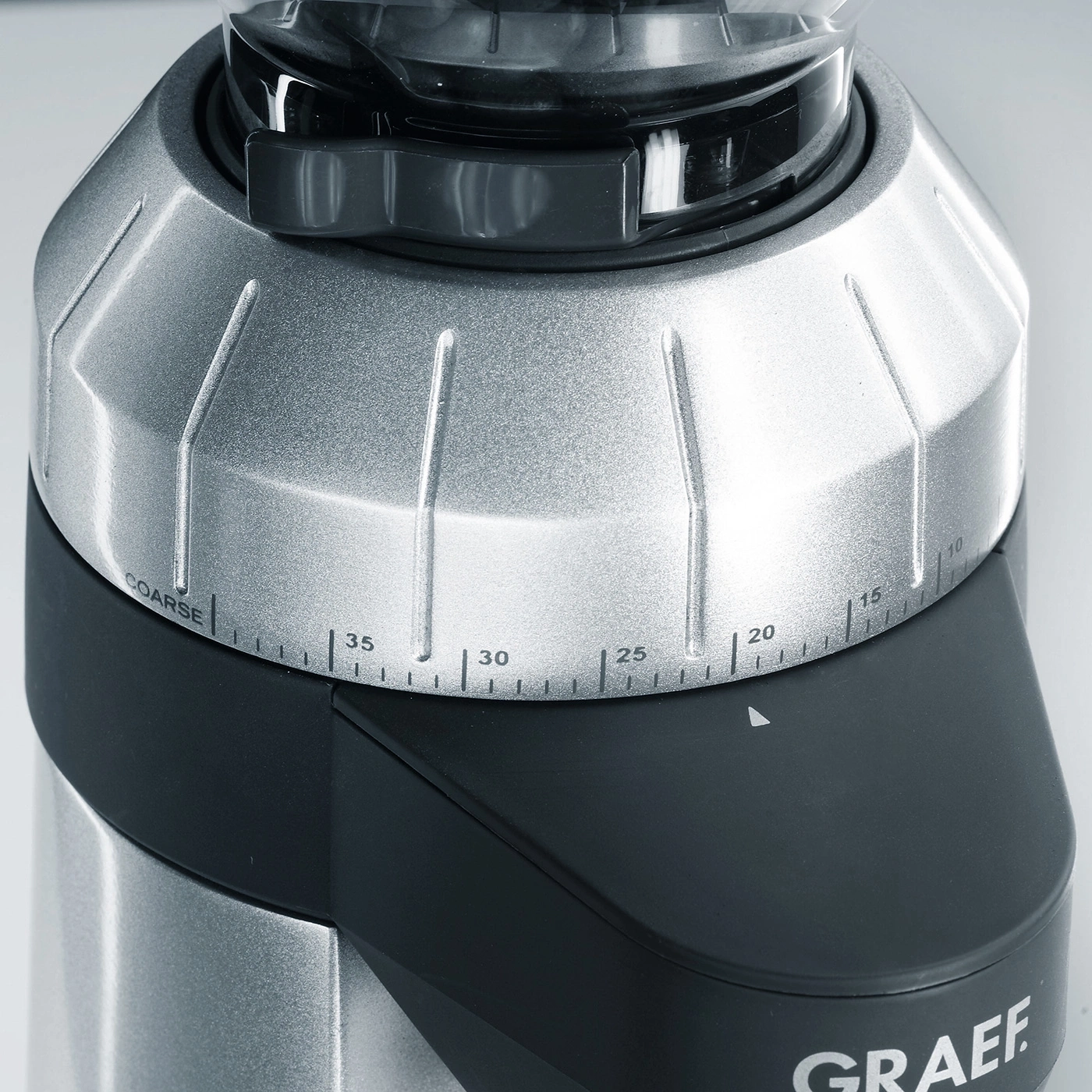 Close-up of a coffee grinder with a grind size adjustment dial