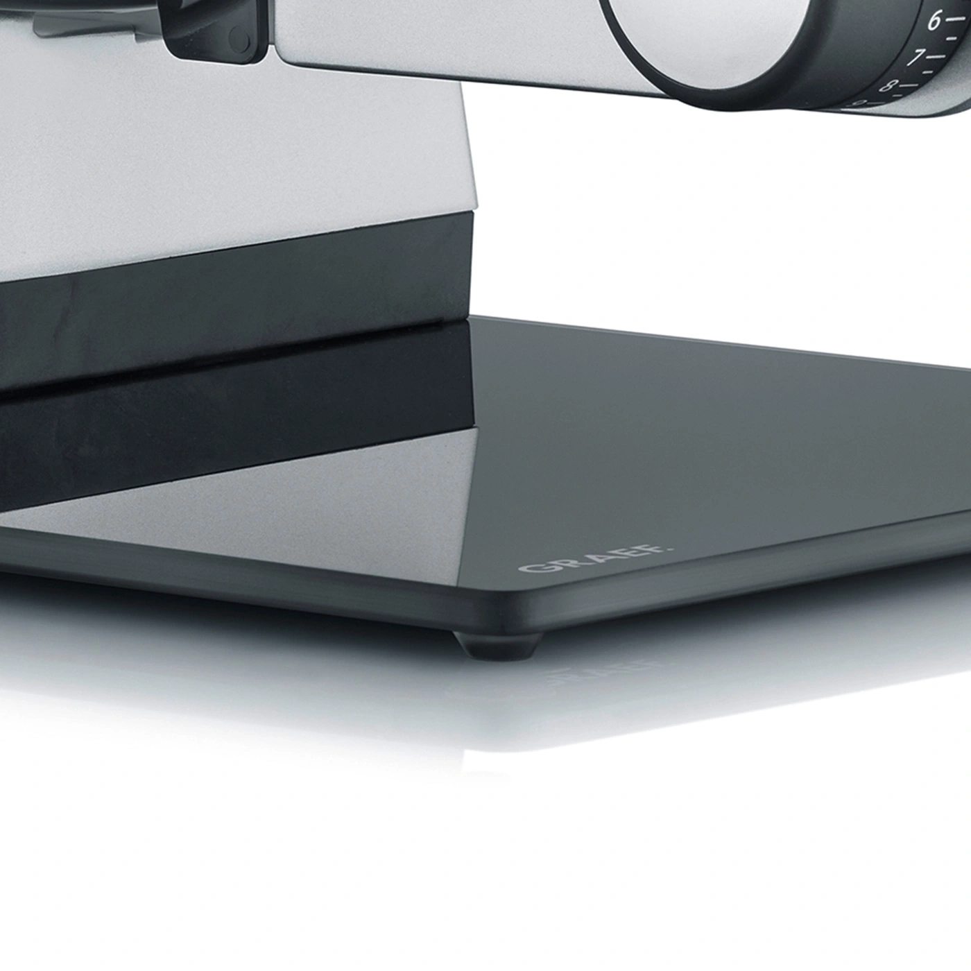 Close-up of a gray meat slicer with the inscription GRAEF on the base.