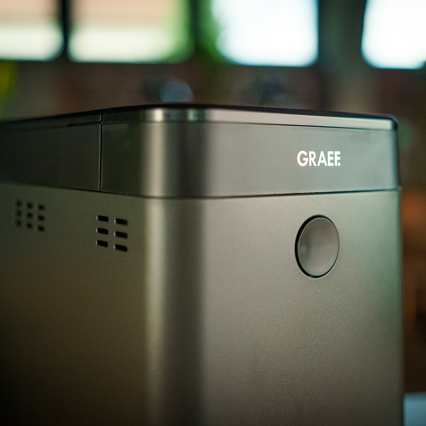 Graef appliance, gray, with logo and button, close-up, detail shot, device