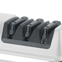 A white knife sharpener with three slots, numbered 1, 2, and 3.