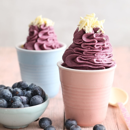 Blaubeer-Desserts in Bechern mit weißer Schokolade und Blaubeeren