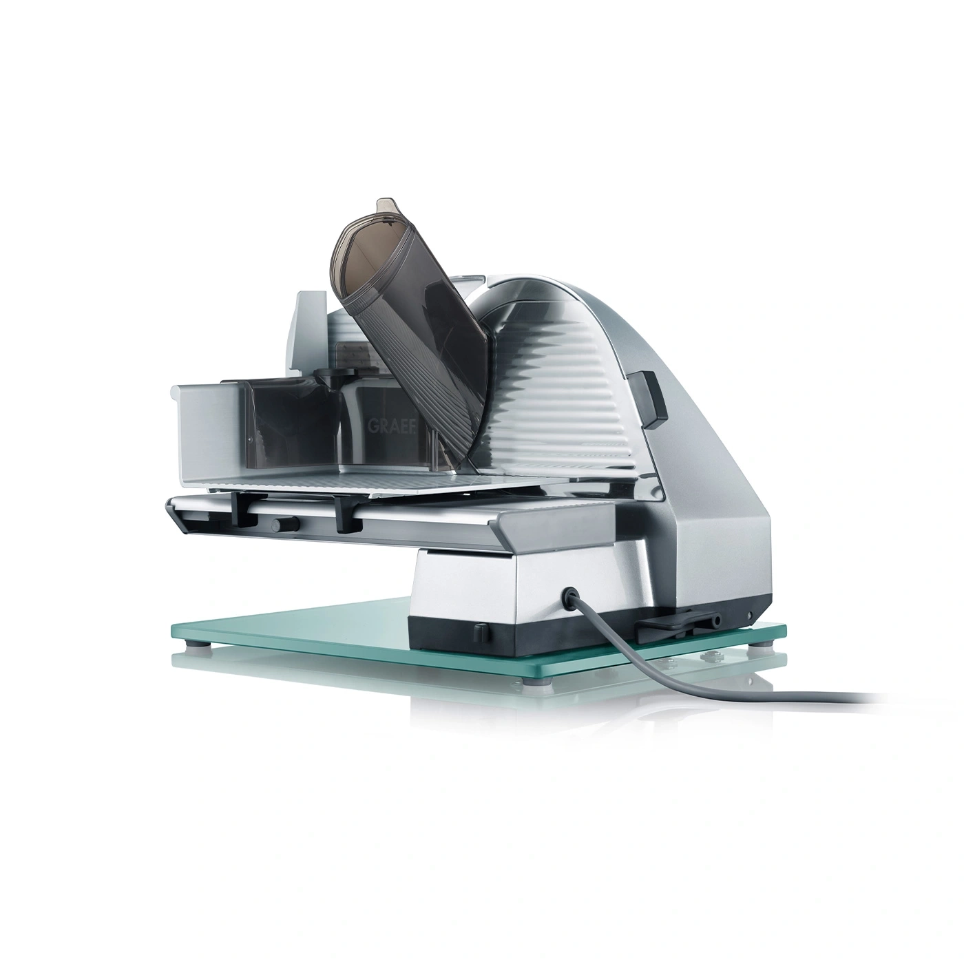 Graef slicer, silver, electric, with glass plate, detail shot, isolated on white