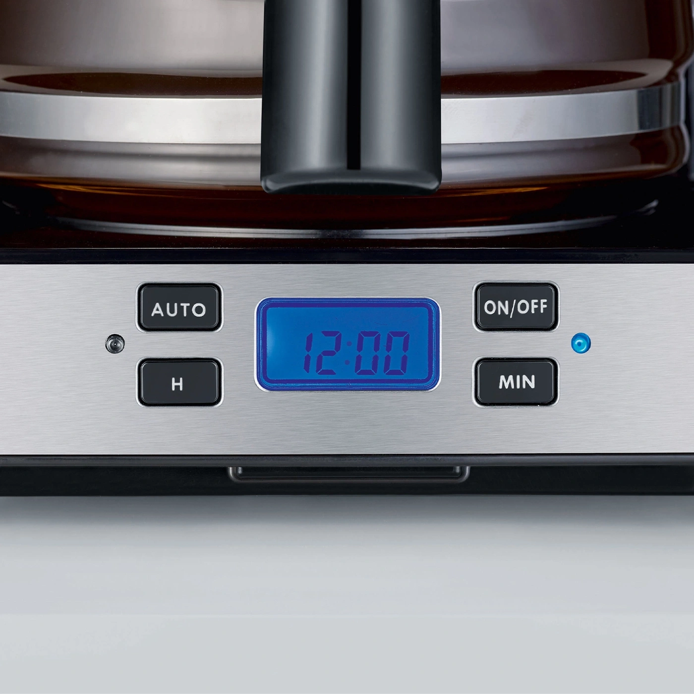 Coffee machine with digital display, buttons, and time showing 12:00.