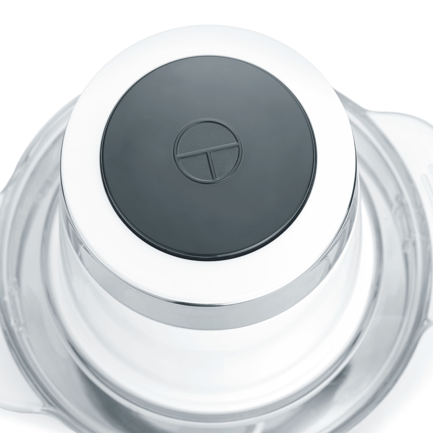 Close-up of a kitchen appliance with a gray button and a white ring around it.