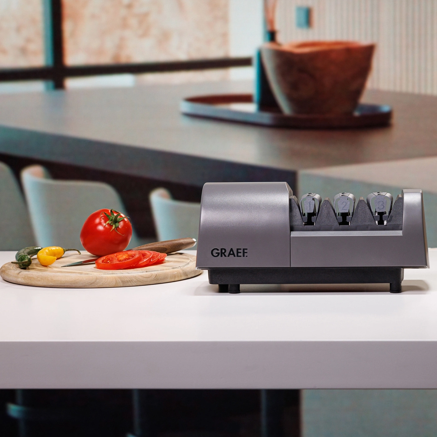 Graef knife sharpener with tomatoes and vegetables on a cutting board