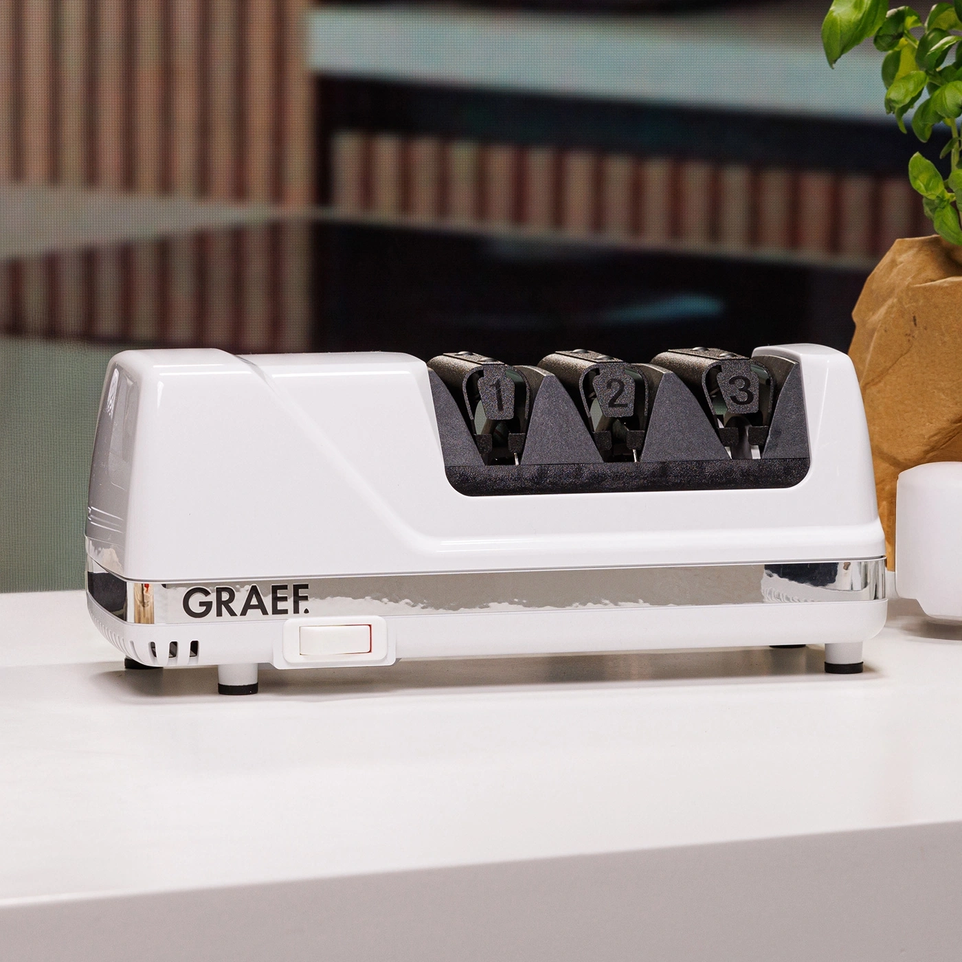 White electric knife sharpener with numbers 1, 2, and 3 on it.
