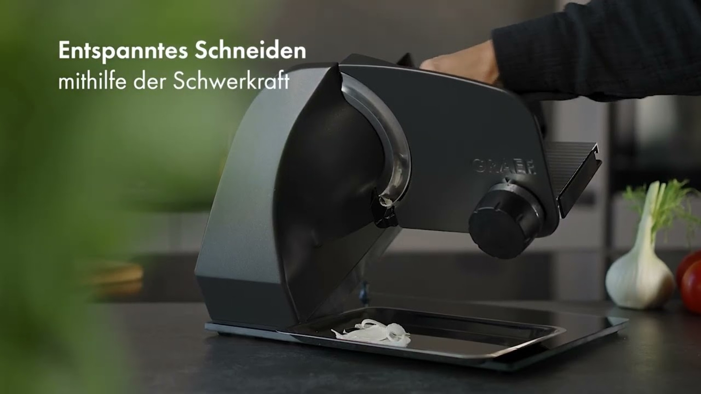 Slicing machine cutting vegetables, with the text 'Relaxed cutting with the help of gravity'.