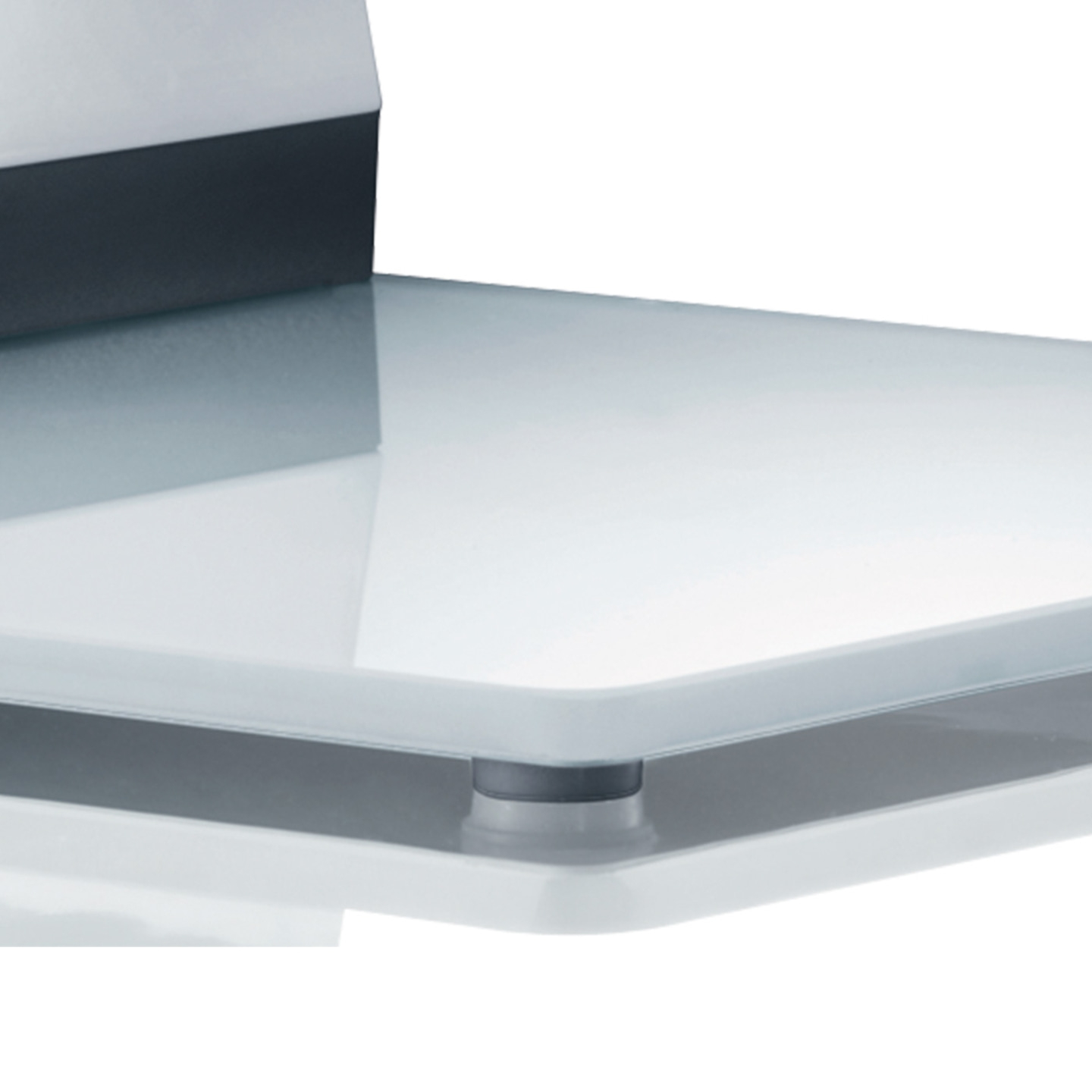 Close-up of a glass shelf with a dark edge and silver supports.