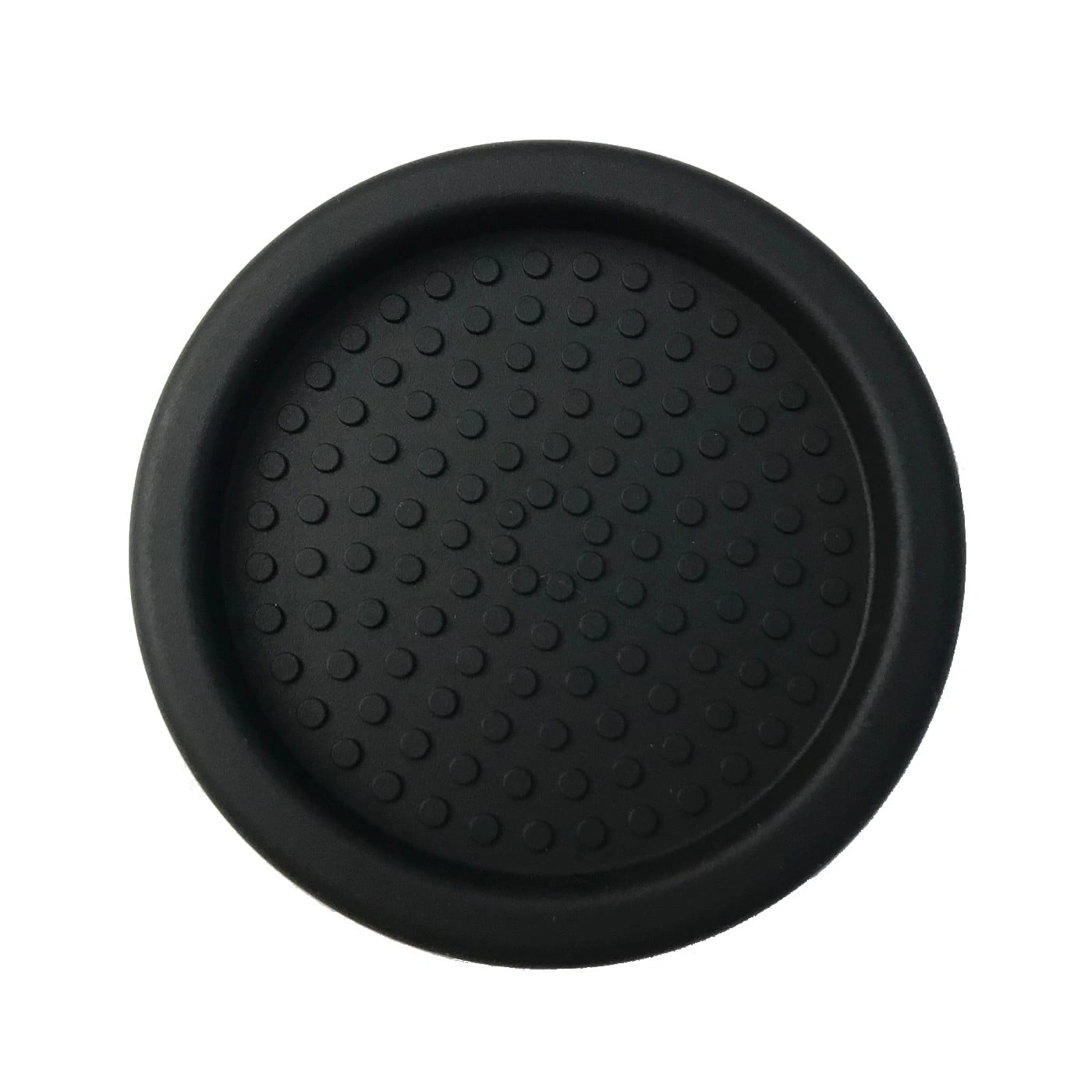 Black drink coaster with circular indentations, close-up detail, isolated object