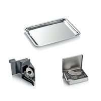Tray, cheese cutter and accessories in a metal box. Kitchen utensils.
