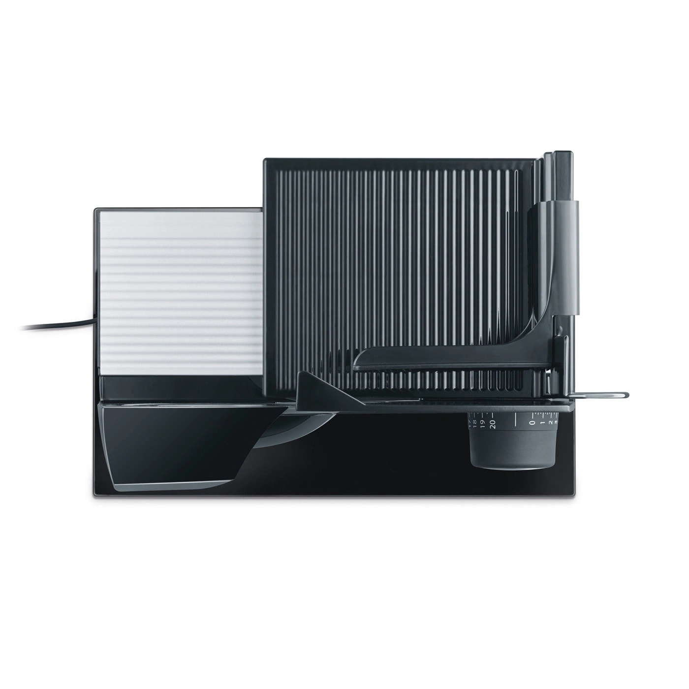 Black electric food slicer with adjustment dial and ribbed surface, isolated.